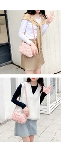 Pink PU leather crossbody bag with clover patterns shown on a model in outdoor setting