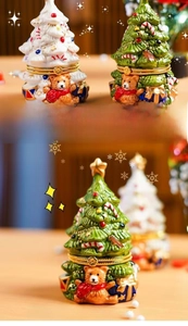 Detailed close-up of ceramic Christmas tree jewelry boxes with teddy bear ornaments
