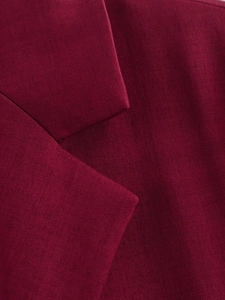 Detailed close-up of dark red plaid blazer fabric showing premium twill texture