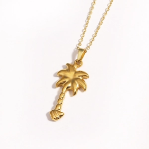 Macro detail of a golden coconut tree pendant necklace made of high-quality titanium steel
