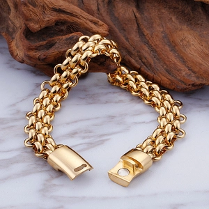 Macro shot of multi-row braided gold chain bracelet with magnetic clasp on marble