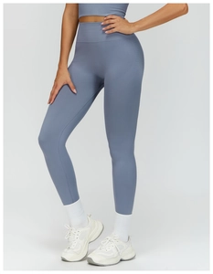 Detail of high-waist seamless yoga pants featuring ribbed waistband and tummy control fabric