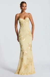 Detail of light yellow maxi dress featuring 3D floral embroidery and corset bodice
