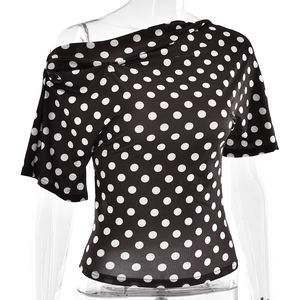 Close-up of black one-shoulder T-shirt with white polka dot pattern and waist detail