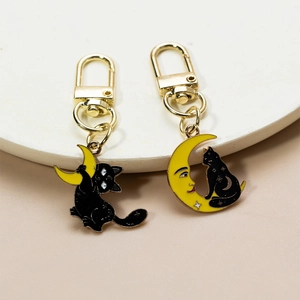 Cute punk black cat keychains with yellow moon and sun charms on a golden metal base