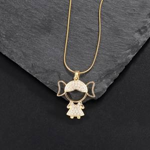 Macro detail of gold girl pendant with sparkling zircon paving on high polish metal