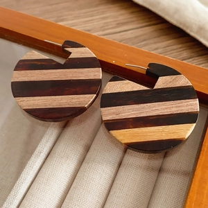 Macro view of geometric round resin earrings with retro wood grain texture detail