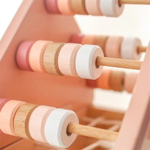 Close-up of pastel wooden abacus beads on a minimalist Nordic educational toy for toddlers