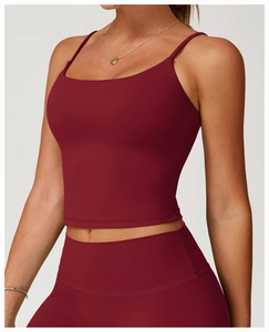 Close-up of deep wine red yoga tank top showing cross-back straps and brushed fabric detail