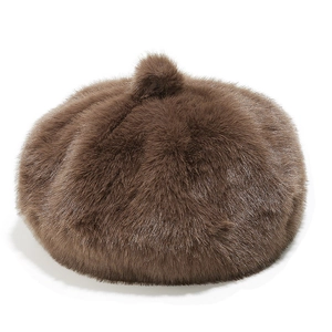 Close-up of fluffy faux mink fur beret in chocolate brown with a stylish top pom-pom