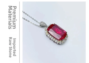 Detailed macro view of a rectangular pigeon blood ruby pendant with halo diamond setting