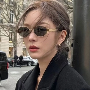 Retro oval sunglasses with gold metal frames and dark grey lenses for stylish women