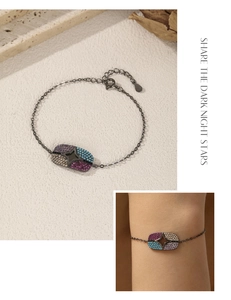 Detail of S925 silver black chain bracelet featuring colorful star-patterned gemstones