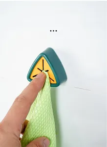 Detail of green triangle towel holder with yellow silicone cross-insert for easy hanging