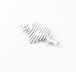 Detailed close-up of a silver ECG heartbeat brooch with a polished metallic finish