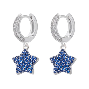 Detailed close-up of silver star earrings featuring blue and white pavé cubic zirconia