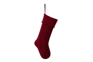 Detail of red cable knit Christmas stocking with hanging loop and textured wool finish