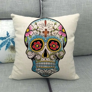 Close-up of bohemian linen pillow cover with colorful Mexican sugar skull patterns