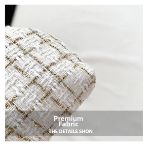 Close-up of elegant ivory tweed fabric with premium metallic gold thread weaving detail