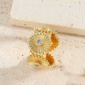 Detail of 14K gold plated flower ring featuring daisy petals and zircon stones on a stone base