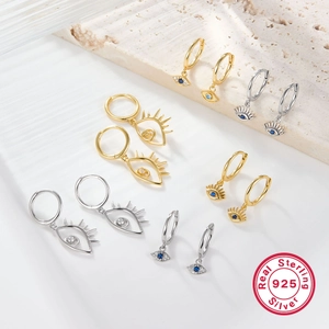 Detailed view of S925 sterling silver evil eye earrings with blue zircon in gold and silver