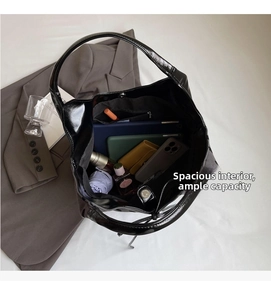 Top view of spacious black patent leather tote bag showing large storage capacity