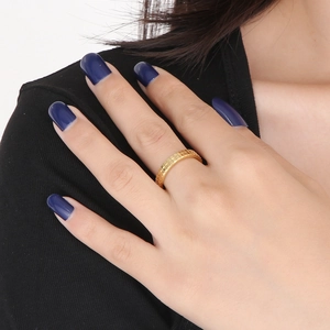 Detail of 18k gold plated stainless steel ring with embossed checkered pattern on hand