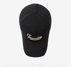 Top view of black cotton baseball cap showing detailed gold Fearnice embroidery