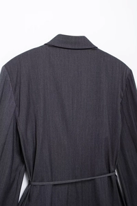 Detailed back view of dark grey pinstripe blazer featuring a matching waist belt detail