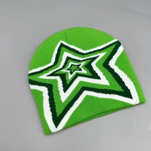 Detailed knit texture of green winter beanie with star pattern and layered fabric finish
