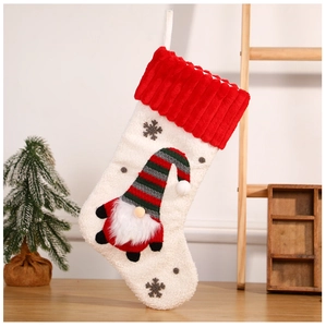 Detailed view of red Christmas stocking with 3D gnome doll and plush snowflake embroidery