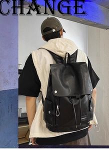 Dettaglio dello zaino in pelle nera con chiusura a coulisse e tasca laterale con zip