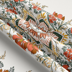Detailed view of vibrant orange floral patterns and green leaves on soft woven fabric