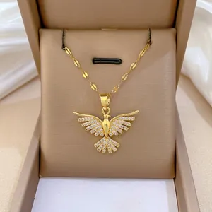 Elegant gold phoenix wings necklace with sparkling crystals on a premium jewelry gift box