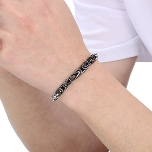 Men's two-tone black and silver Byzantine chain bracelet in stainless steel on wrist