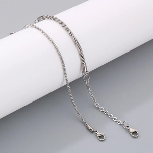 Detail of silver stainless steel woven mesh chain bracelet with lobster clasp and extender