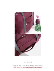 Detail of travel duffel bag showing luggage sleeve for suitcase handle attachment