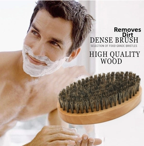 Detail of wooden beard brush with high-density black bristles for men's grooming