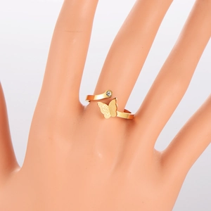 Gold plated matte butterfly open ring with cubic zirconia on a minimalist display