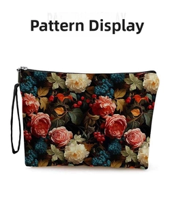 Detailed view of the vintage floral and grape pattern on the woven cosmetic bag
