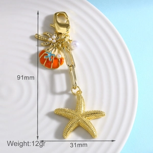Detail of starfish and enamel shell keychain with pearls and 91mm length measurement