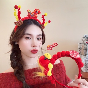Detail of red plush lion dance headband with spring tassels for New Year festive style