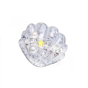 Cute shell hair clip for girls with white pearls and gold star on white background