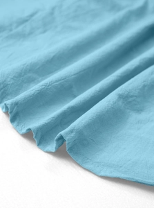 Macro view of light blue linen fabric texture and hem stitching on men's summer set