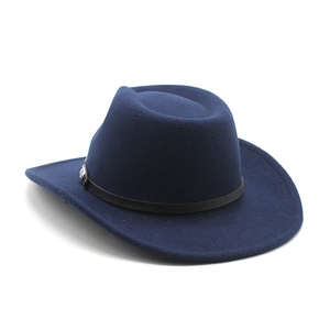 Close-up of navy wool felt cowboy hat featuring black leather band and silver concho