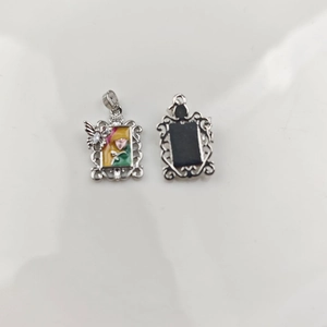 Detailed view of vintage silver hollow pendant with colorful floral and butterfly enamel