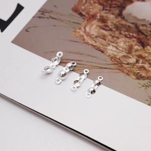 Close-up of four sizes of S925 sterling silver clam shell bead tips for jewelry making