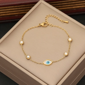 Elegant gold evil eye bracelet with blue charms and sparkling crystals on jewelry display