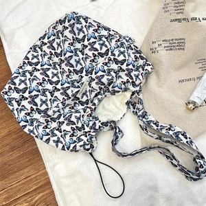 Close-up of butterfly printed canvas tote bag with drawstring detail and woven label