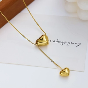 Elegant gold stainless steel double heart pendant necklace on white gift card